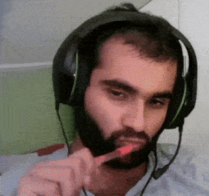 a man wearing headphones is brushing his teeth