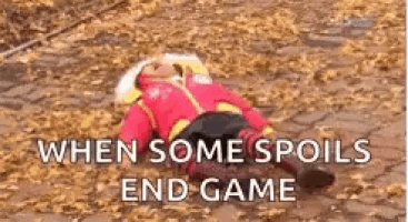 a person in a superhero costume is laying on a pile of leaves .
