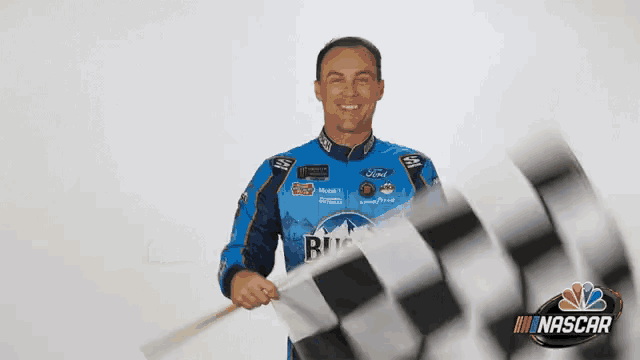 a man is waving a checkered flag in the air .