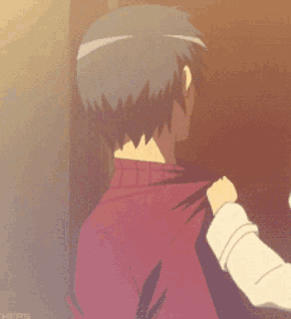 a man in a red sweater is being slapped by another person