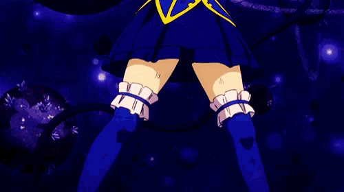 a girl in a blue dress is holding a whip in her hand .