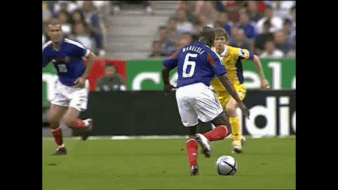 a soccer player with the number 6 on his back kicks the ball