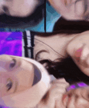 a blurry picture of a woman 's face with a purple and blue background
