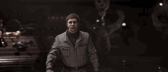 a man in a gray jacket is giving the middle finger