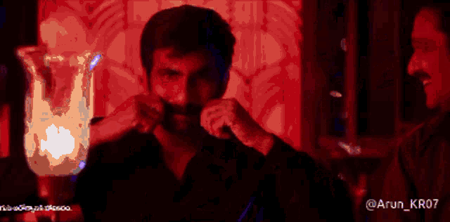 a blurred image of a man with the name arun_kr07 on the bottom right