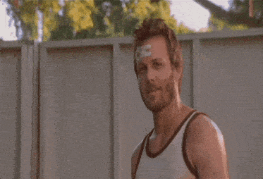 a man with a bandage on his forehead has the letter s on it