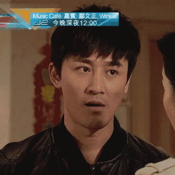 a man with a surprised look on his face in front of a music cafe advertisement