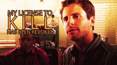 a man stands in front of a sign that says " my license to kill has been revoked "