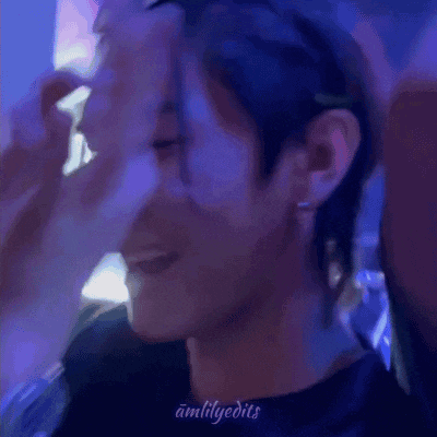 a close up of a person 's face with a blue light behind it .