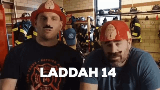 two men wearing firefighter hats with the words laddah 14 on the bottom