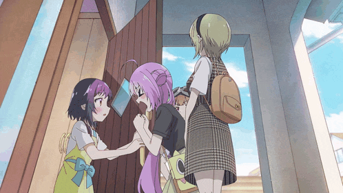 a girl with purple hair is being held by another girl in a yellow apron