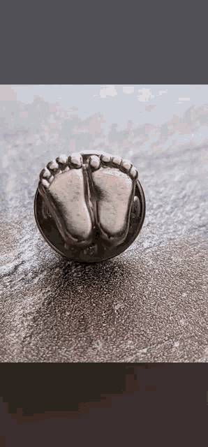 a coin with a picture of a baby 's foot on it .