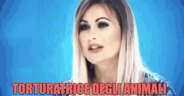 a woman in a blue shirt with the words torturatrice degli animali on the bottom