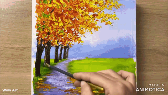 a person is painting a row of trees with yellow leaves on a canvas