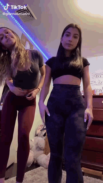 two girls are standing next to each other in a room with tiktok written on the bottom of the video