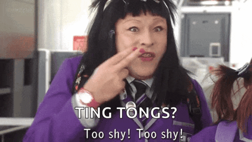 a woman in a purple suit is making a funny face and says " ting tongs "
