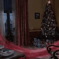 a living room with a christmas tree and a bowl of candy canes