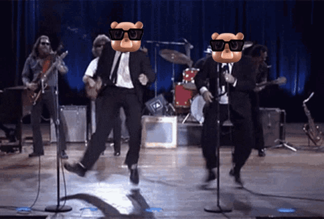 two bears wearing sunglasses are dancing on stage