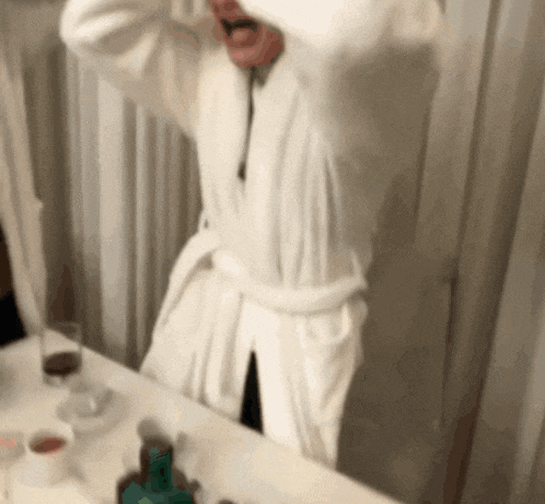 a man in a white robe is sitting at a table
