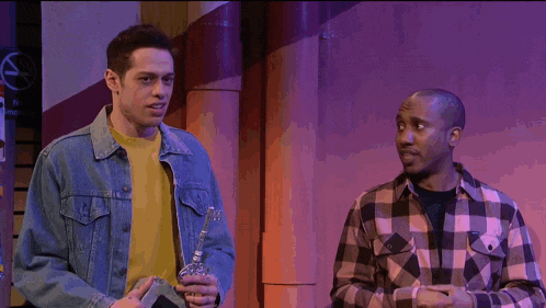 a man in a plaid shirt says i did while standing next to two other men