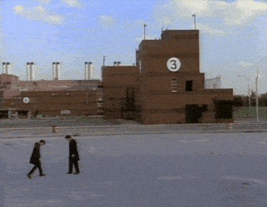 a large brick building with the number 3 on it