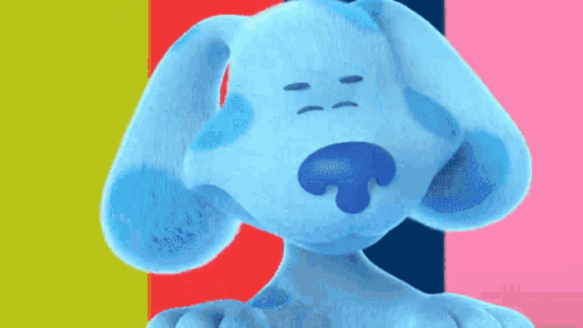 a blue stuffed animal is sitting in front of a striped background .