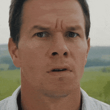 a close up of a man 's face making a funny face