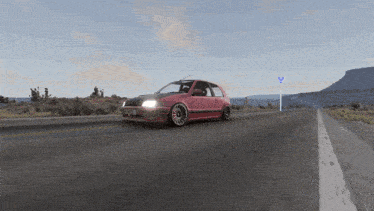 a red car is driving down a road with a sign that says ' y ' on it