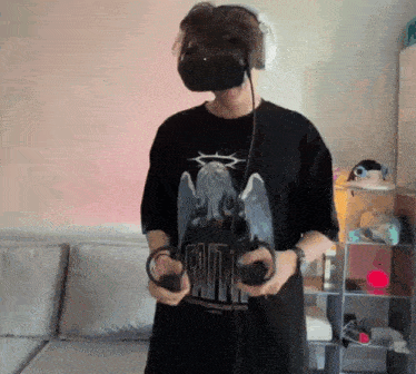 a man wearing a virtual reality headset and headphones is holding a controller .