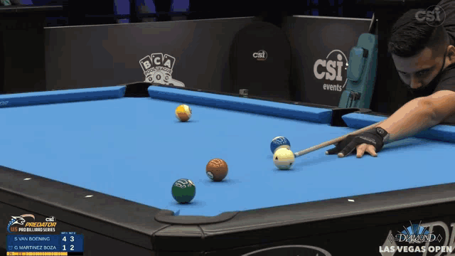 a man is playing pool in front of a banner that says csi events