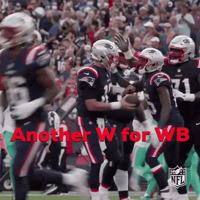 a group of patriots football players on the field with the words another w for wb in red