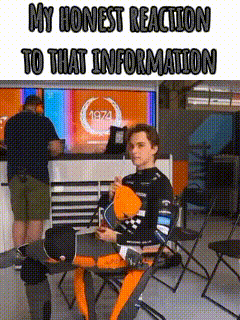 a man is sitting at a table with his legs crossed in front of a tv .