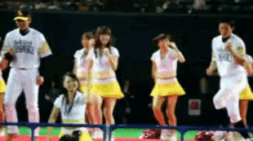 a group of cheerleaders are performing on a baseball field