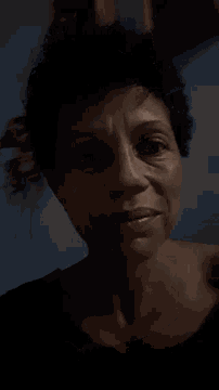 a close up of a woman 's face with a blue background
