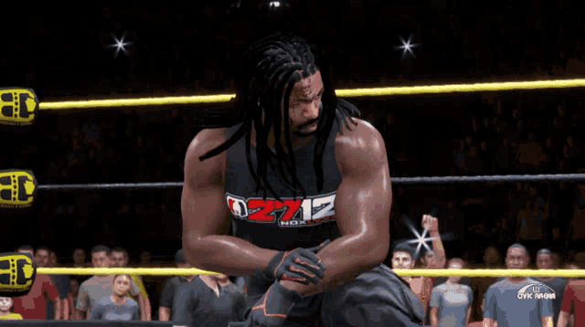 a man in a wrestling ring is wearing a shirt that says zz