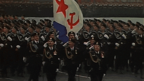 a group of soldiers marching in a parade with a flag with the number 7 on it
