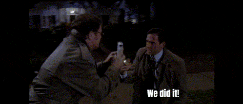 two men in suits and ties are standing next to each other and one of them is saying we did it .