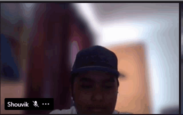a blurry picture of a man with the name shouvik on the bottom right