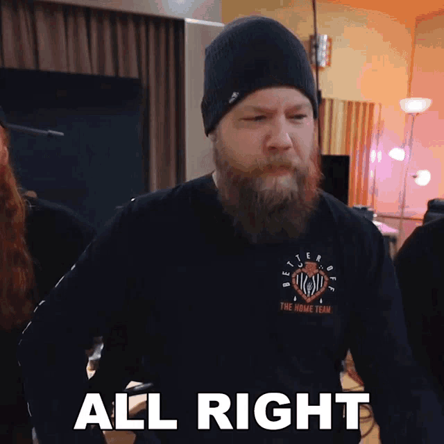 a man with a beard wearing a shirt that says the home team