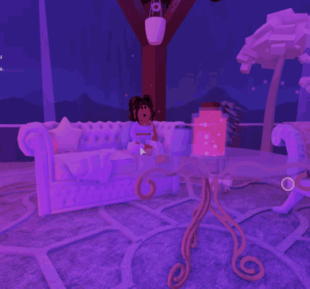 a girl sitting on a couch in a room with purple lights