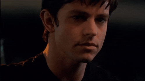 a close up of a man 's face with a serious look on his face