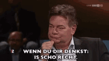 a man with his hand on his chin says " wenn du dir denkst "
