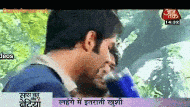 a tv screen shows a man talking to another man in a foreign language