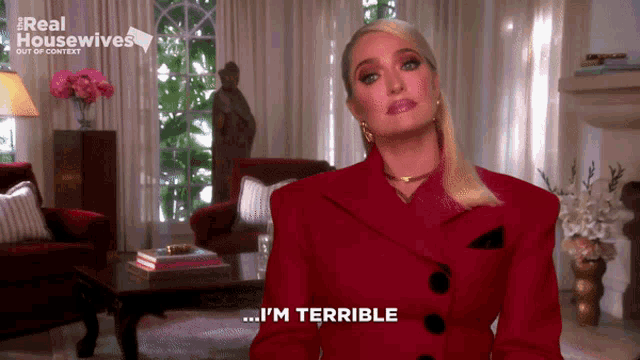 a woman in a red jacket says i 'm terrible in a living room