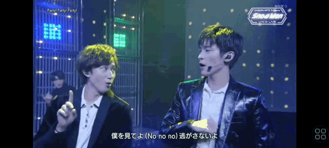 two men on a stage with the word snowman on the bottom right