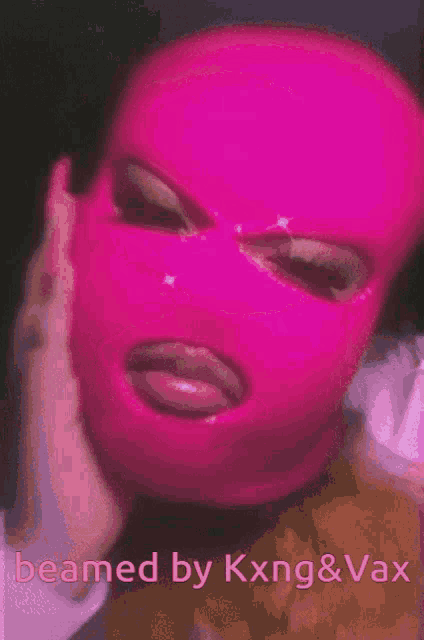 a woman wearing a pink ski mask with the words " beamed by kxng & vax " below her