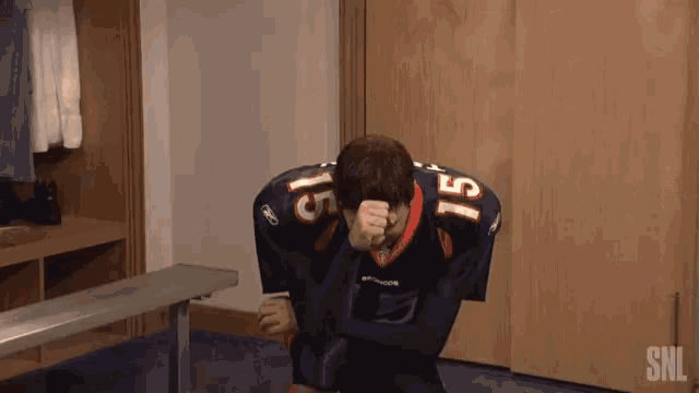 a man wearing a football jersey with the number 15 on it
