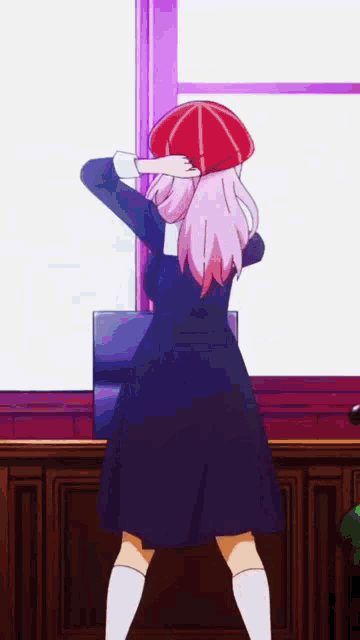 a girl with pink hair is standing in front of a window .