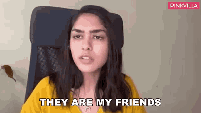 a woman in a yellow shirt is sitting in a chair and says they are my friends