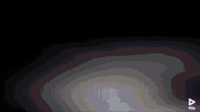 a blurred image with a play button in the corner
